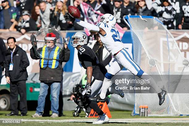 Vontae Davis of the Indianapolis Colts defends a pass intended for Michael Crabtree of the Oakland Raiders during their NFL game at Oakland Alameda...