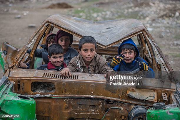 Syrian kids pose for a photograph inside a wreckage of a car as Syrians live freely against all odds in Jarabulus after its cleansing of Daesh...