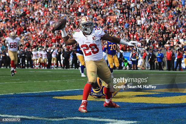 Carlos Hyde of the San Francisco 49ers celebrates scoring a touchdown during the first quarter against the Los Angeles Rams at Los Angeles Memorial...