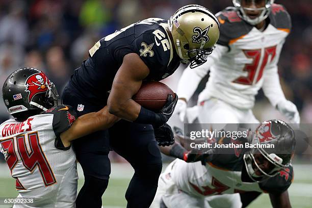 Mark Ingram of the New Orleans Saints is tackled by Brent Grimes of the Tampa Bay Buccaneers at the Mercedes-Benz Superdome on December 24, 2016 in...