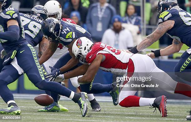 Fullback Marcel Reece of the Seattle Seahawks fumbles the ball against the Arizona Cardinals at CenturyLink Field on December 24, 2016 in Seattle,...