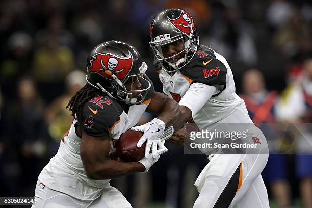 Jameis Winston of the Tampa Bay Buccaneers hands off to Jacquizz Rodgers of the Tampa Bay Buccaneers at the Mercedes-Benz Superdome on December 24,...