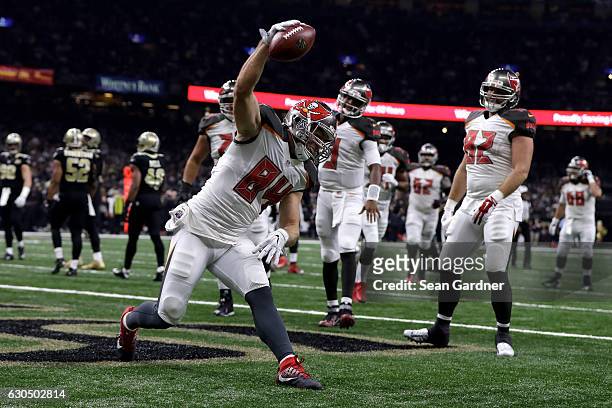 Cameron Brate of the Tampa Bay Buccaneers scores a touchdown against the New Orleans Saints at the Mercedes-Benz Superdome on December 24, 2016 in...