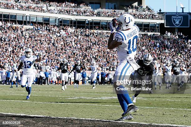 Donte Moncrief of the Indianapolis Colts scores on a 24-yard touchdown catch against the Oakland Raiders during their NFL game at Oakland Alameda...