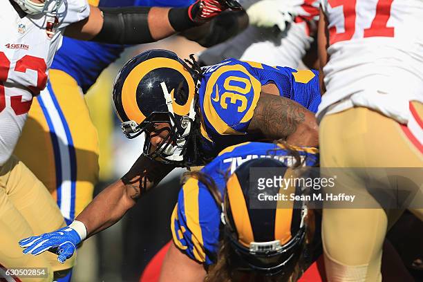 Todd Gurley of the Los Angeles Rams rushes for a 1-yard touchdown during the first quarter against the San Francisco 49ers at Los Angeles Memorial...