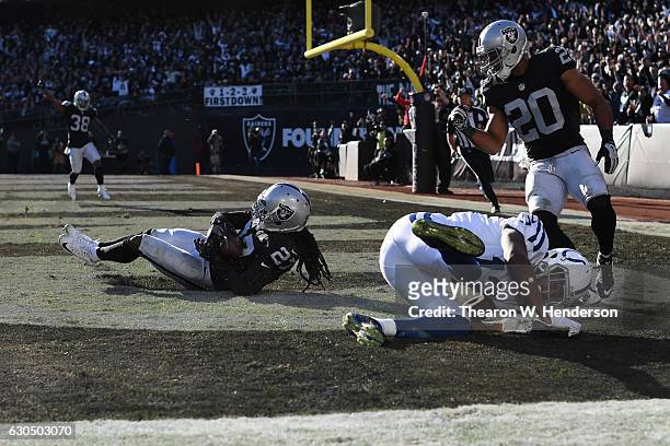 Reggie Nelson of the Oakland Raiders intercepts a pass intended for T.Y. Hilton of the Indianapolis Colts in the endzone during their NFL game at...