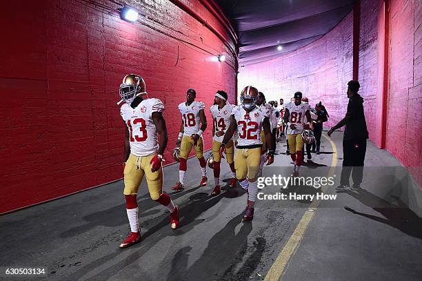 Aaron Burbridge of the San Francisco 49ers leads teammates onto the field before the game against the Los Angeles Rams at Los Angeles Memorial...