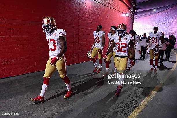 Aaron Burbridge of the San Francisco 49ers leads teammates onto the field before the game against the Los Angeles Rams at Los Angeles Memorial...