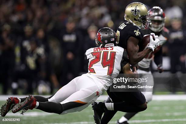 Michael Thomas of the New Orleans Saints is tackled by Brent Grimes of the Tampa Bay Buccaneers at the Mercedes-Benz Superdome on December 24, 2016...