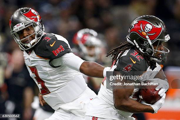 Jameis Winston hands the ball to Jacquizz Rodgers of the Tampa Bay Buccaneers against the New Orleans Saints at the Mercedes-Benz Superdome on...