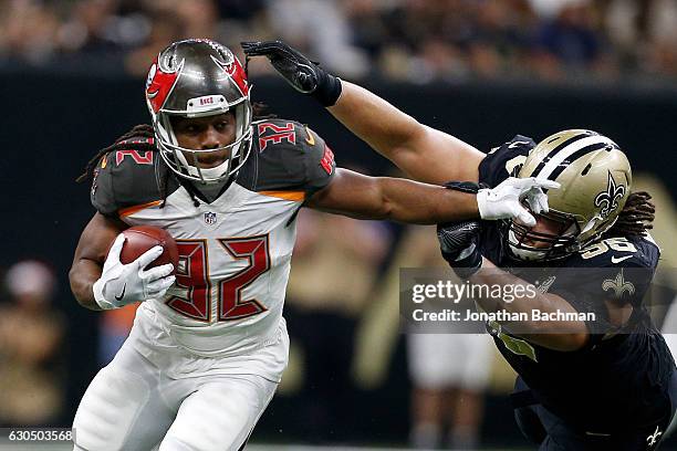 Jacquizz Rodgers of the Tampa Bay Buccaneers avoids a tackle by Tyeler Davison of the New Orleans Saints at the Mercedes-Benz Superdome on December...