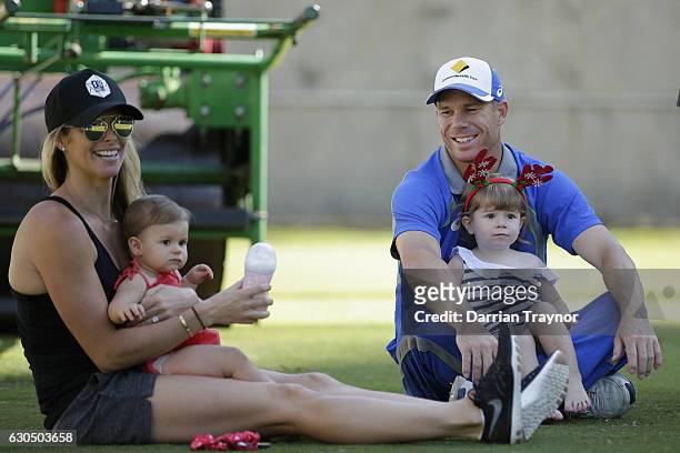 David Warner takes a break with his wife Candice and children Indi and Ivy during an Australian nets session on December 25, 2016 in Melbourne,...