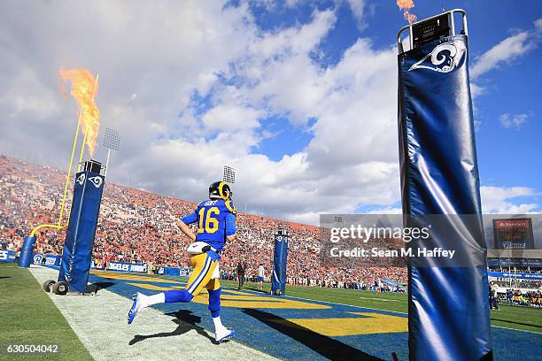 Jared Goff of the Los Angeles Rams runs onto the field before the game against the San Francisco 49ers at Los Angeles Memorial Coliseum on December...