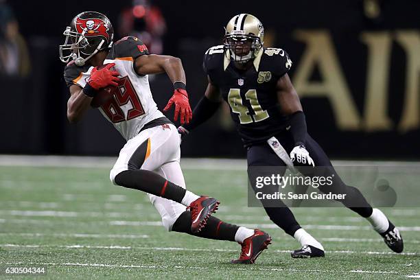 Russell Shepard of the Tampa Bay Buccaneers avoids a tackle by Roman Harper of the New Orleans Saints at the Mercedes-Benz Superdome on December 24,...