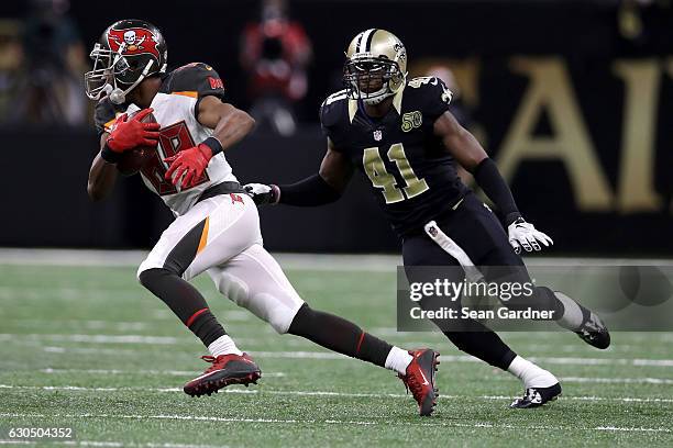 Russell Shepard of the Tampa Bay Buccaneers avoids a tackle by Roman Harper of the New Orleans Saints at the Mercedes-Benz Superdome on December 24,...