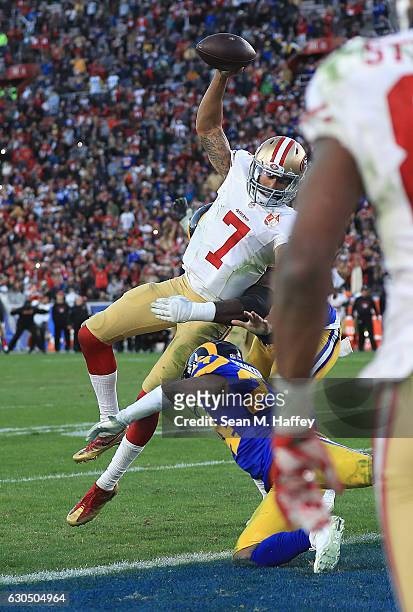 Colin Kaepernick of the San Francisco 49ers jumps into the end zone for a two point conversion during the fourth quarter against the Los Angeles Rams...