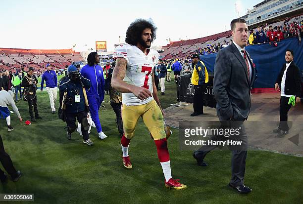 Colin Kaepernick of the San Francisco 49ers walks off the field after defeating the Los Angeles Rams 22-21 at Los Angeles Memorial Coliseum on...