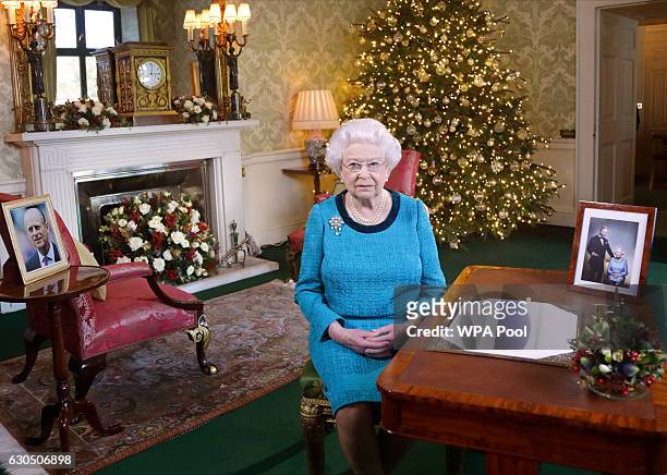 Queen Elizabeth II sits at a desk in the Regency Room after recording her Christmas Day broadcast to the Commonwealth at Buckingham Palace on...