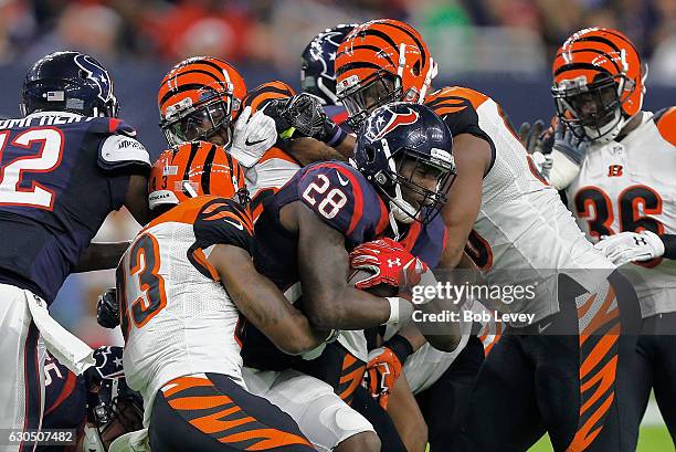 Alfred Blue of the Houston Texans is wrapped up by George Iloka of the Cincinnati Bengals in the second half at NRG Stadium on December 24, 2016 in...