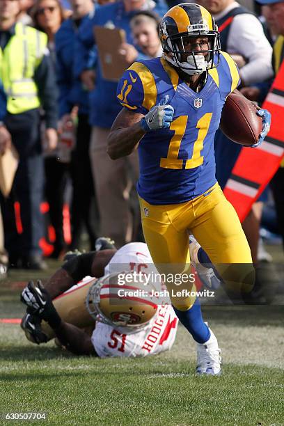 Tavon Austin of the Los Angeles Rams gets by Gerald Hodges of the San Francisco 49ers at the Los Angeles Memorial Coliseum on December 24, 2016 in...