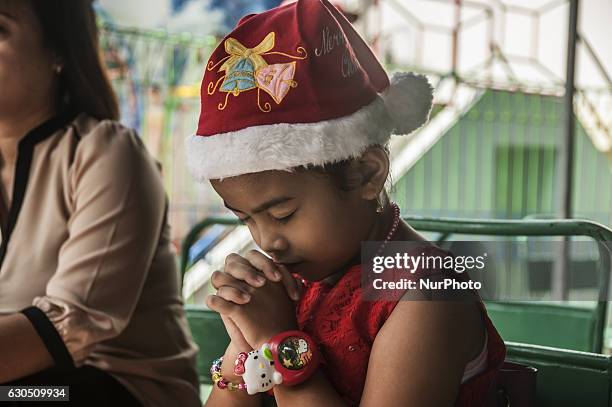 Child pray when children attend mass in celebration of Christmas in Sacred Heart of Jesus Catholic Church in Yogyakarta, Indonesia, on December 25,...