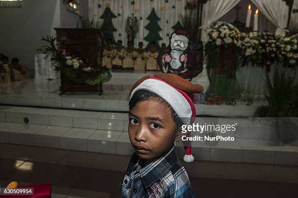 Child pose when attend mass in celebration of Christmas in Sacred Heart of Jesus Catholic Church in Yogyakarta, Indonesia, on December 25, 2016....