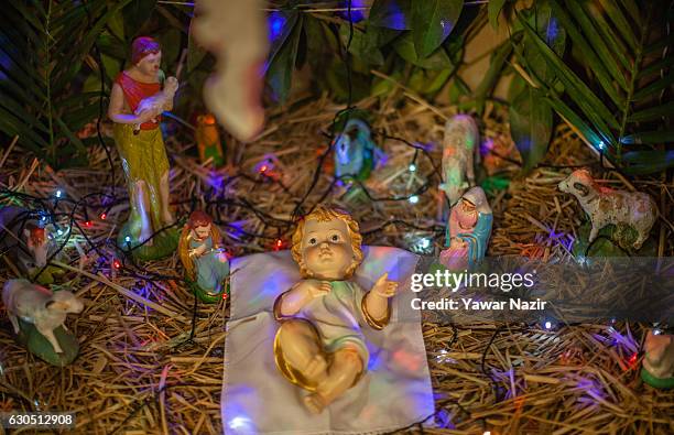 Nativity scene is on display inside the Holy Family Catholic Church during Christmas on December 25, 2016 in Srinagar, the summer capital of Indian-...