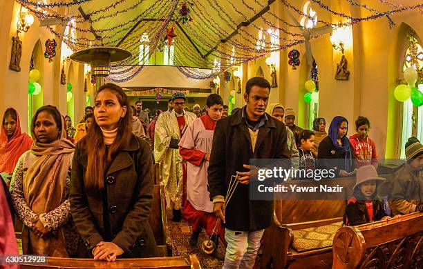 Christians attend Christmas mass inside the Holy Family Catholic Church during Christmas on December 25, 2016 in Srinagar, the summer capital of...