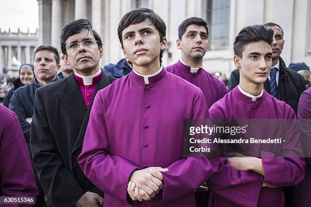 Young Seminarists look up as Pope Francis delivers his Christmas 'Urbi et Orbi' blessing message from the central balcony of St Peter's Basilica on...