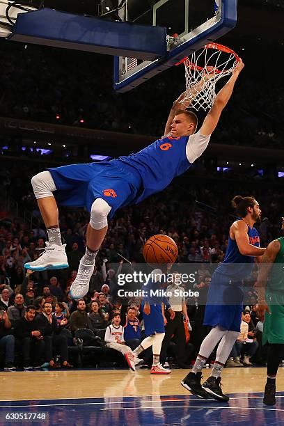 Kristaps Porzingis of the New York Knicks dunks the ball against the Boston Celtics at Madison Square Garden on December 25, 2016 in New York City....