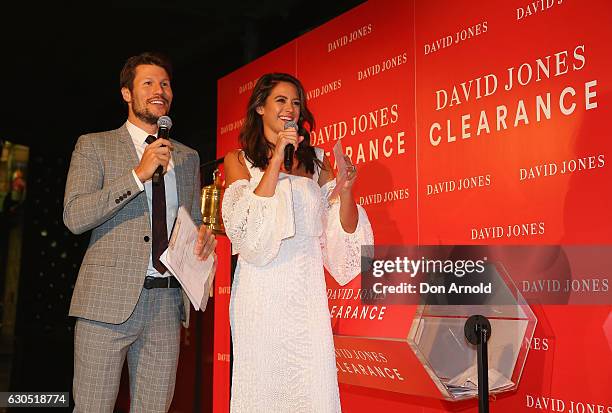 Jason Dundas and Jesinta Campbell read the results of a lottery outside the David Jones Elizabeth St tore just prior to opening during the Boxing Day...