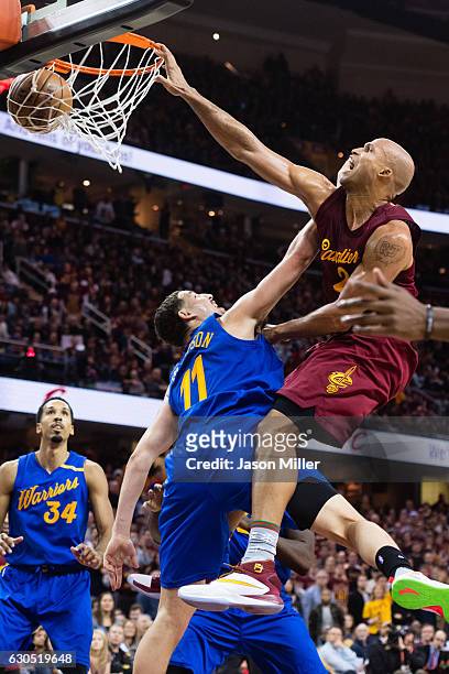 Richard Jefferson of the Cleveland Cavaliers dunks over Klay Thompson of the Golden State Warriors during the second half at Quicken Loans Arena on...