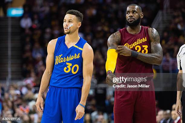 Stephen Curry of the Golden State Warriors and LeBron James of the Cleveland Cavaliers pause on the court during the first half at Quicken Loans...