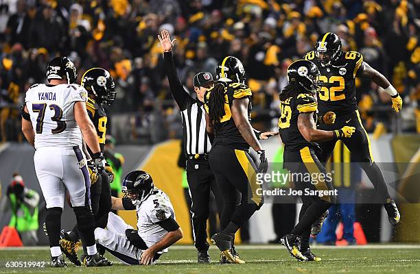 Bud Dupree of the Pittsburgh Steelers celebrates with Johnny Maxey after sacking Joe Flacco of the Baltimore Ravens in the first half during the game...