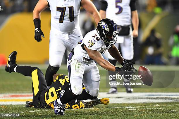 Kenneth Dixon of the Baltimore Ravens fumbles the ball in the first half during the game against the Pittsburgh Steelers at Heinz Field on December...