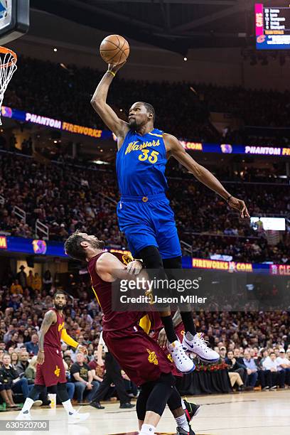 Kevin Durant of the Golden State Warriors tries to dunk over Kevin Love of the Cleveland Cavaliers during the first half at Quicken Loans Arena on...
