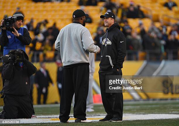 Head Coach Mike Tomlin of the Pittsburgh Steelers talks with Head Coach John Harbaugh of the Baltimore Ravens during warmups before the game at Heinz...