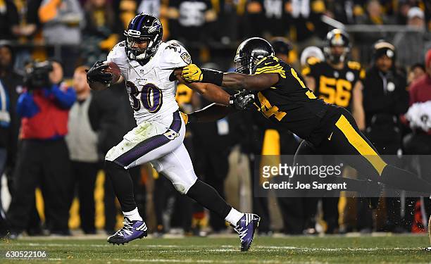 Kenneth Dixon of the Baltimore Ravens rushes against Lawrence Timmons of the Pittsburgh Steelers in the third quarter during the game at Heinz Field...