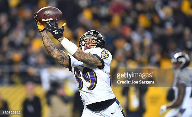Steve Smith of the Baltimore Ravens catches a pass from Joe Flacco for an 18 yard touchdown reception in the third quarter during the game against...