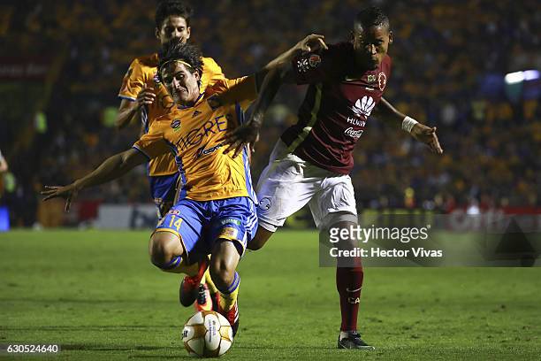 Michael Arroyo of America struggles for the ball with Jorge Estrada of Tigres during the Final second leg match between Tigres UANL and America as...
