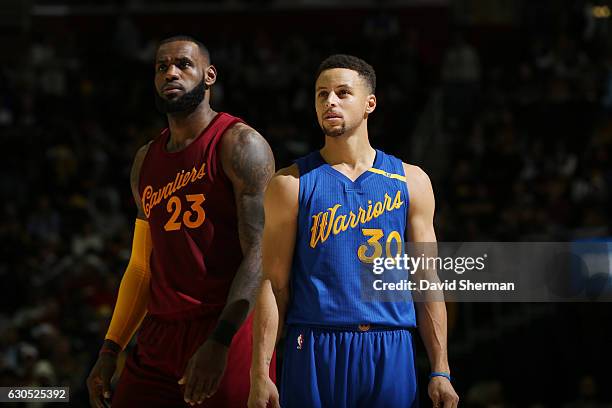 LeBron James of the Cleveland Cavaliers and Stephen Curry of the Golden State Warriors react to a play during the game on December 25, 2016 at...