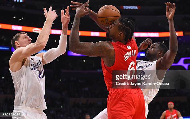 DeAndre Jordan of the Los Angeles Clippers, Timofey Mozgov and Luio Deng of the Los Angeles Lakers go for a rebound in the first quarter of the game...
