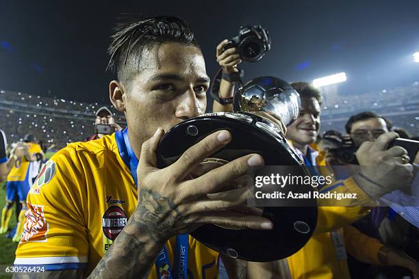 Javier Aquino of Tigres celebrates by kissing the trophy after the Final second leg match between Tigres UANL and America as part of the Torneo...