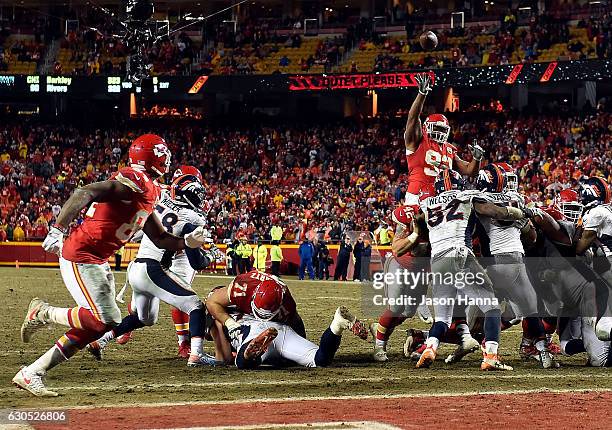 Nose tackle Dontari Poe of the Kansas City Chiefs passes to tight end Demetrius Harris in the end zone for a touchdown during the 4th quarter of the...