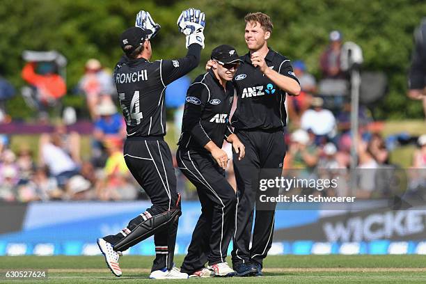Lockie Ferguson of New Zealand is congratulated by team mates after dismissing Shakib Al Hasan of Bangladesh during the first One Day International...