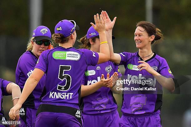 Julie Hunter is congratuklated by Heather Knight of the Hobart Hurricanes after taking the wicket of Shelley Nitschke of the Adelaide Strikers during...