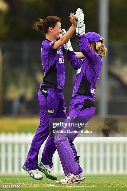 Julie Hunter is congratulated by Georgia Redmayne of the Hobart Hurricanes after taking the wicket of Shelley Nitschke of the Adelaide Strikers...