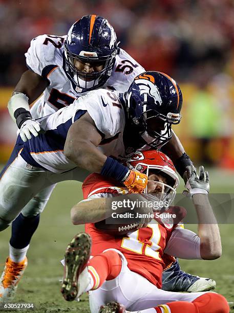 Quarterback Alex Smith of the Kansas City Chiefs is tackled by inside linebacker Todd Davis and inside linebacker Corey Nelson of the Denver Broncos...