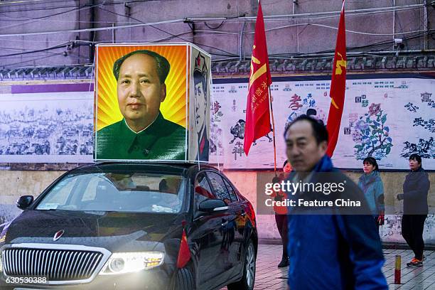 People parade on a street to mark the 123rd birth anniversary of Chairman Mao on December 26, 2016 in Huaxian, China. PHOTOGRAPH BY Feature China /