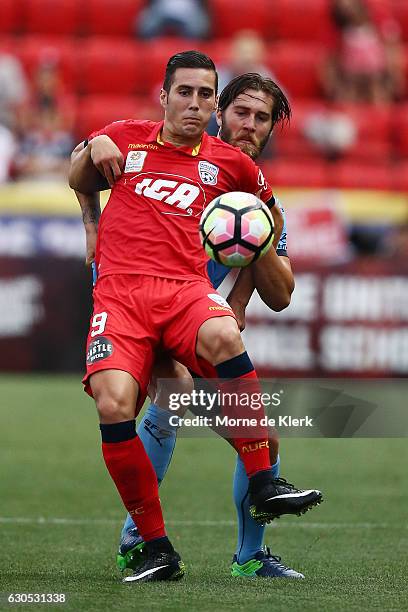 Sergio Guardiola of Adelaide United and Joshua Brilliante of Sydney compete for the ball during the round 12 A-League match between Adelaide United...